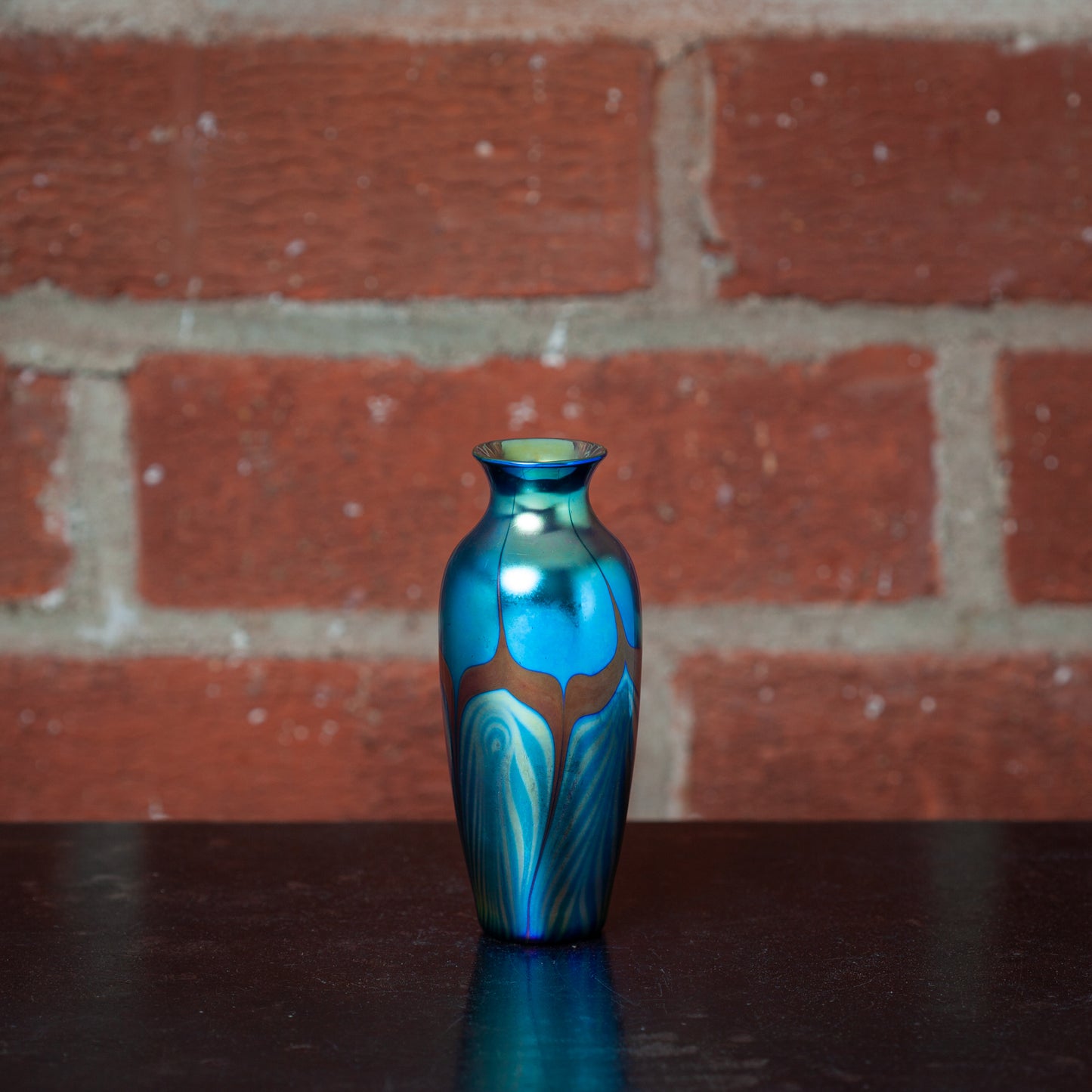 Small art glass vase with blue feather decoration